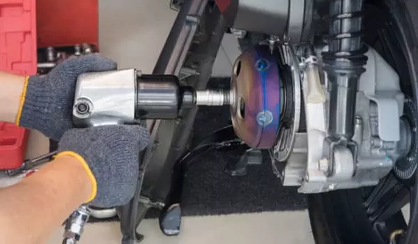Garagiste changeant le kit d'embrayage d'un deux-roues